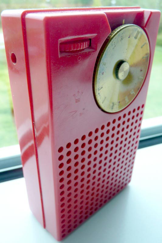 A red Regency TR-1 transistor radio.