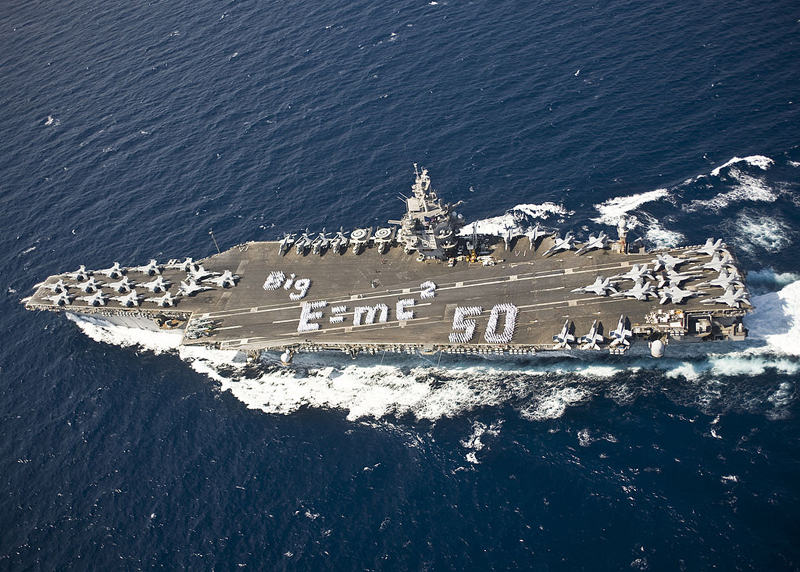 Sailors spell out E=MC2 on the flight deck of the aircraft carrier USS Enterprise (CVN 65) to commemorate the 50th anniversary of the ship's commissioning. Enterprise was the first nuclear powered aircraft carrier.