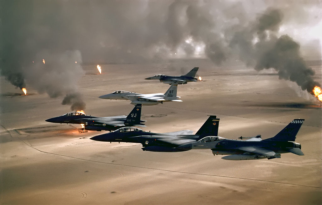 USAF aircraft of the 4th Fighter Wing (F-16, F-15C and F-15E) fly over Kuwaiti oil fires, set by the retreating Iraqi army during Operation Desert Storm in 1991.