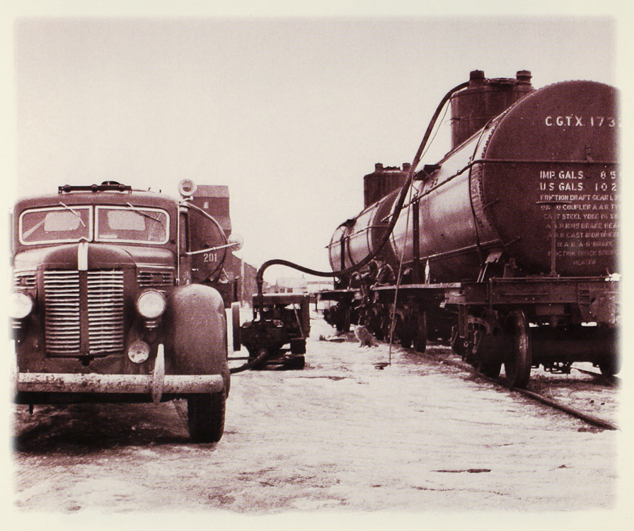 Oil is loaded from a truck to the railhead. Soon, as this method became unfeasible, pipelines were installed to transfer the huge quantities of oil.